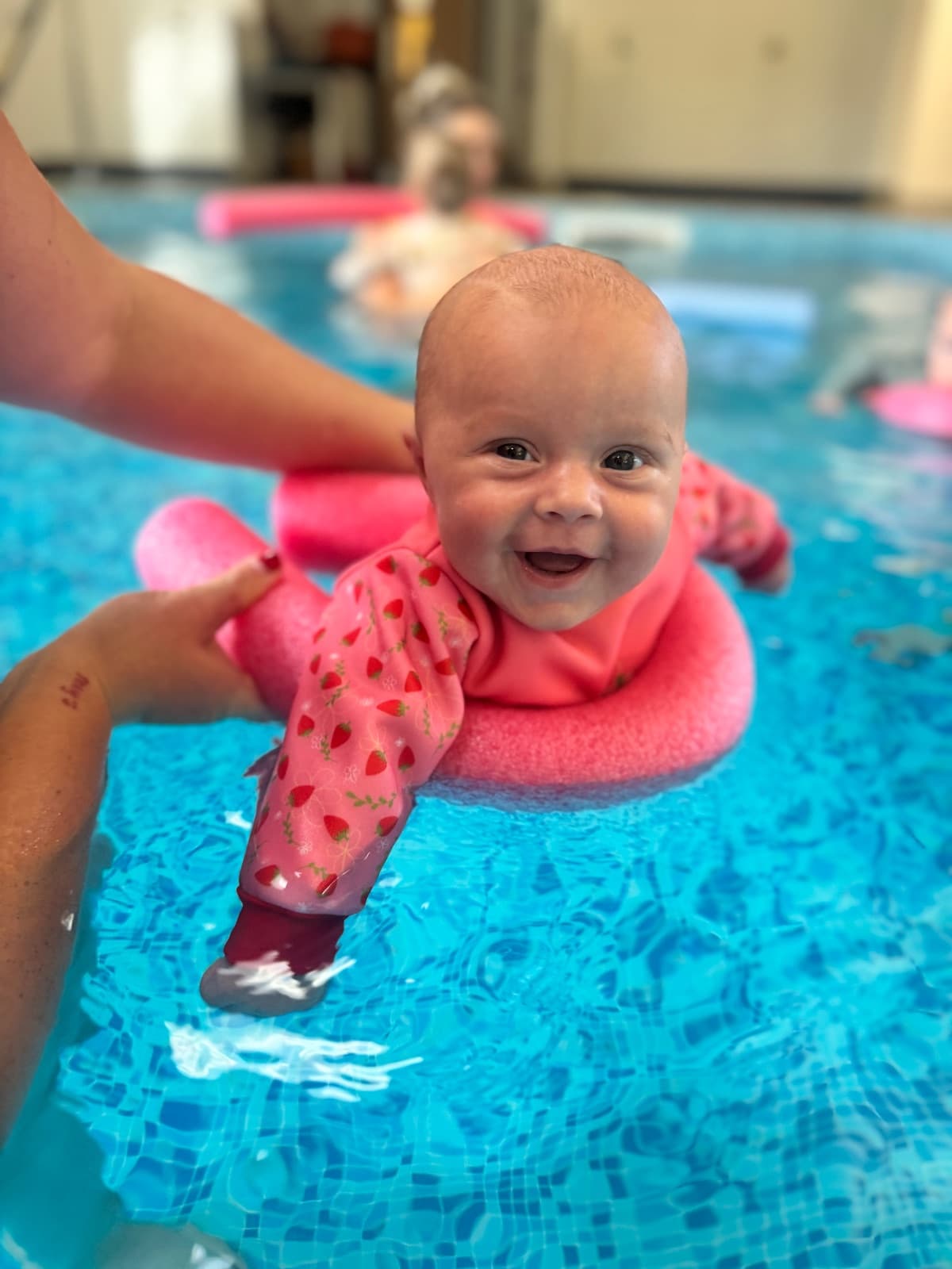 A baby swimming underwater at a Bubble Babies class